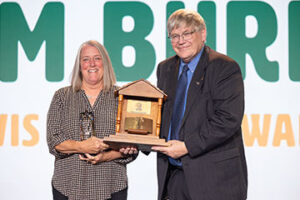 Payne County Farm Bureau President Nancy German (left) accepts the 2024 Oklahoma Farm Bureau Charles L. Roff Award from OKFB President Rodd Moesel during the 2024 OKFB Annual Meeting Awards Banquet Saturday, Nov. 9 in Oklahoma City.