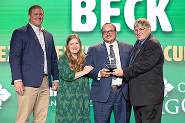 Chastity and Jacob Beck (center) accept the Oklahoma Farm Bureau Young Farmers & Ranchers Excellence in Agriculture Award from OKFB President Rodd Moesel (right) and Brady Bond representing award sponsors Farm Credit of ... during the 2024 OKFB Annual Meeting Awards Banquet Saturday, Nov. 9 in Oklahoma City.