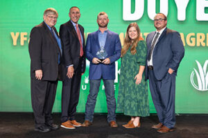 Comanche County Farm Bureau member Chasen Doye (center) receives the 2024 Oklahoma Farm Bureau Young Farmers & Ranchers Achievement Award during the 2024 OKFB Annual Meeting Awards Banquet Saturday, Nov. 9 in Oklahoma City.